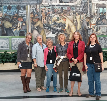 From left: Eliana Saari, Anne Cushman, Joan Tallan, Mary Woodworth, Cindy Davis and Judith Steele in front of the north wall of the Diego Rivera mural, Detroit Industry, at the Detroit Institute of Art. 